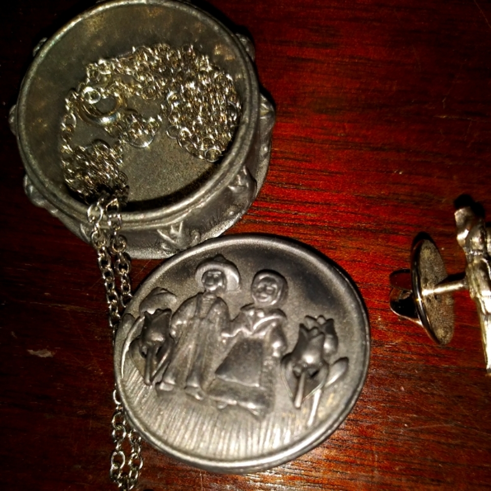 Old man and Woman. Has earrings, round pin, box, necklace, and another pin.